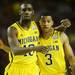 Michigan junior Tim Hardaway Jr. and sophomore Trey Burke walk arms and arm off the court during a break in the action against Syracuse in the second half of the Final Four in Atlanta on Saturday, April 6, 2013. Melanie Maxwell I AnnArbor.com
